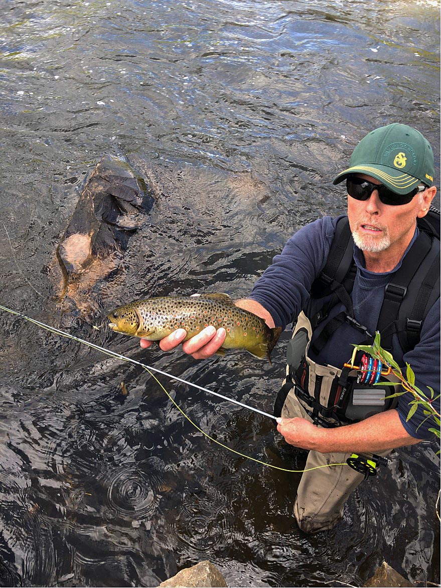 Doug R. battling brown trout with a flyrod on a river somewhere in North America 8/2020