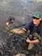 Doug R. battling brown trout with a flyrod on a river somewhere in North America 8/2020