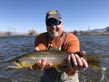 Brad R. lands an excellent sized brown trout while flyfishing a river somewhere in North America 6/2018. 