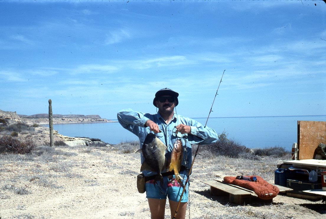Mike dufish with a large triggerfish and a leopard grouper caught from the shore of Los Corrales, Baja, photo by Baja Tim 3/1994