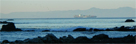 Container ship steaming eastward through the San Pedro Channel as seen from the rocks at the end of Hawthorne Blvd., Palos Verdes.  Catalina Island in the background 4/6/2009