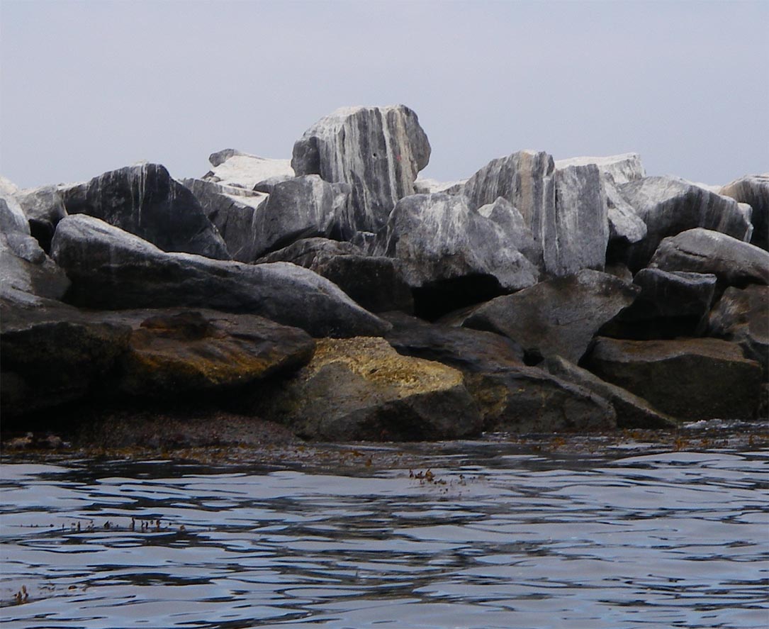 Upright flat rock with a bullet hole marking the spot where Breakwall Darryl and Dufish metered and caught many 2 to 4 pound sand and calico bass along the Federal Breakwall 6/24/2009