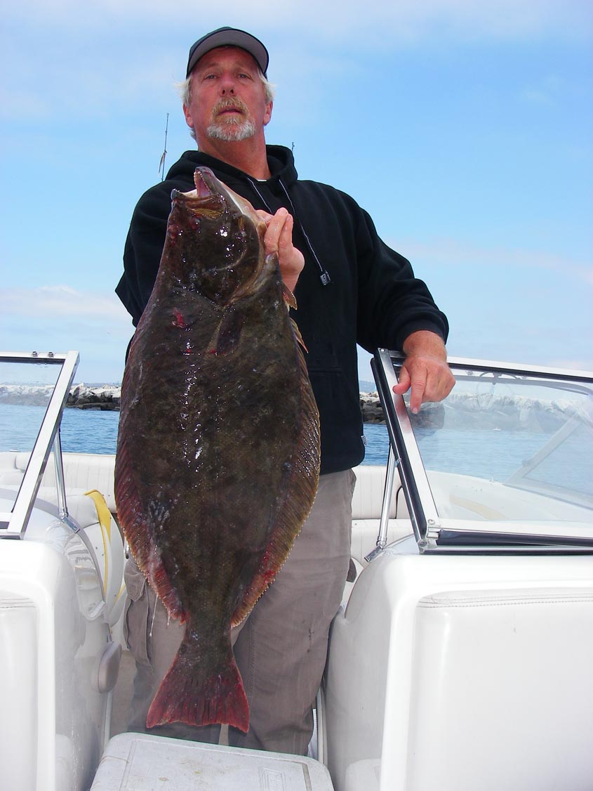 Breakwall Darryl with the 10+ pound halibut he caught at Angels Gate while using a Jerk Shad on a 3/8-ounce lead head 6/24/2009