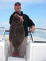 Breakwall Darryl with the 10+ pound halibut he caught at Angels Gate while using a Jerk Shad on a 3/8-ounce lead head 6/24/2009