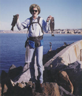 Mike Dufish with two three-taco opaleye from the Redondo Breakwall, Hermosa Beach in the background.
