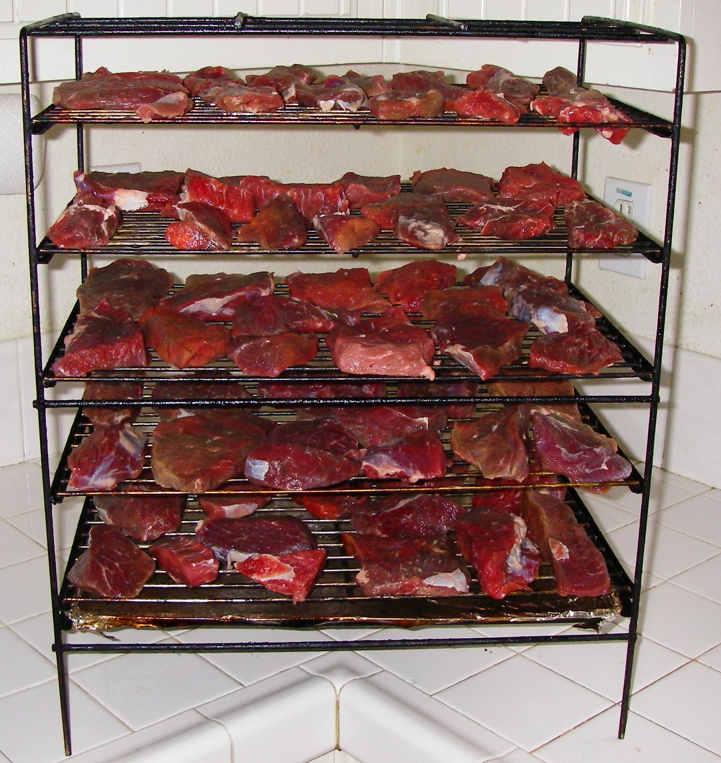 Smoker rack loaded with chuck cross rib roast all cut up for jerky 2/15/2012